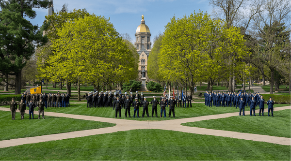 Branches of Notre Dame's ROTC programs standing on the quad with the Golden Dome in the background