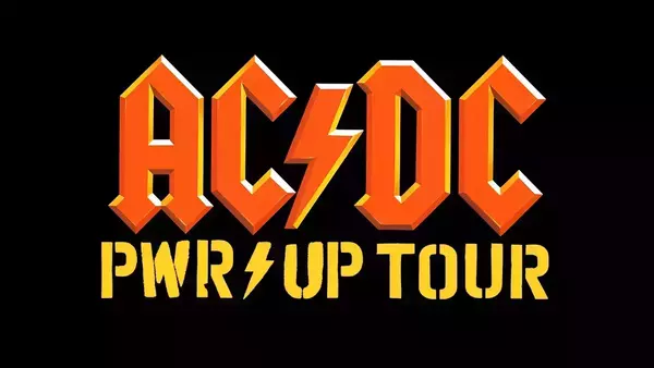 Orange 3D-style AC/DC logo with a yellow lightning bolt, above yellow stencil text "PWR⚡UP TOUR" also featuring a lightning bolt.